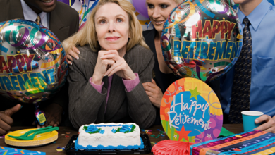 people gathered around a cake at a retirement party