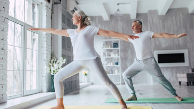 Senior couple is doing fitness training at home. Doing yoga together. Healthy lifestyle concept.